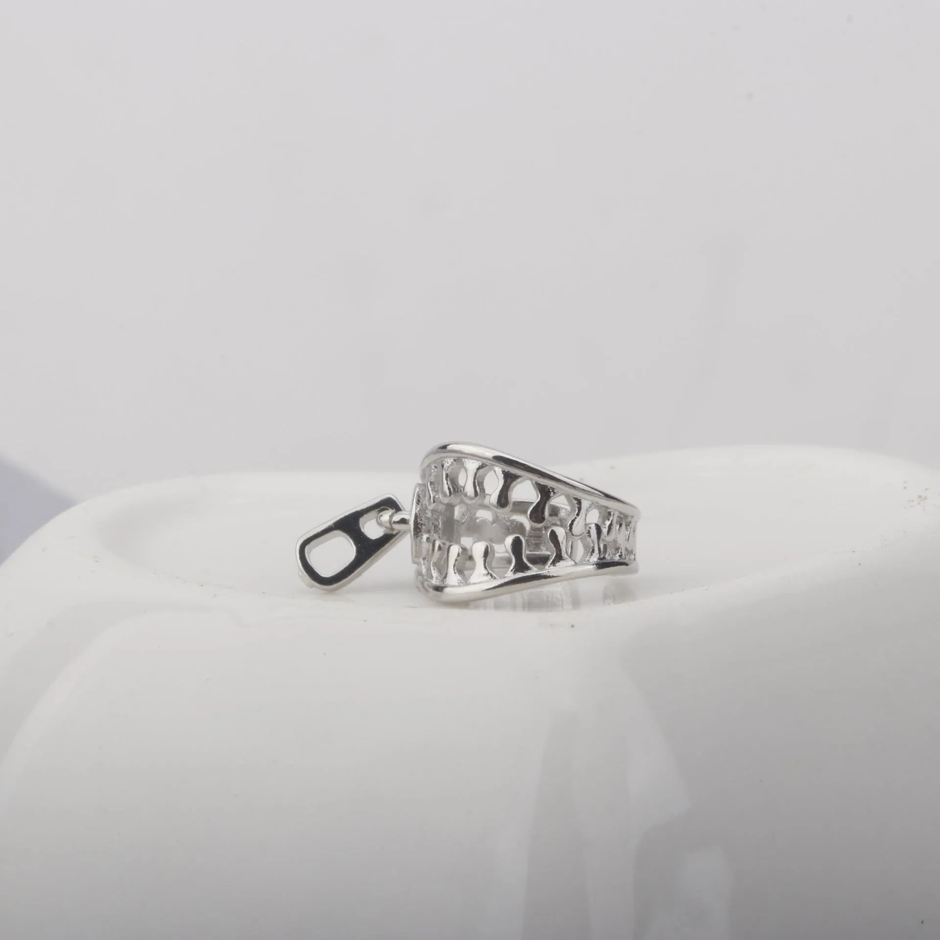 Copper geometric ear clip with zipper closure in ES862 colour, showing simple line design