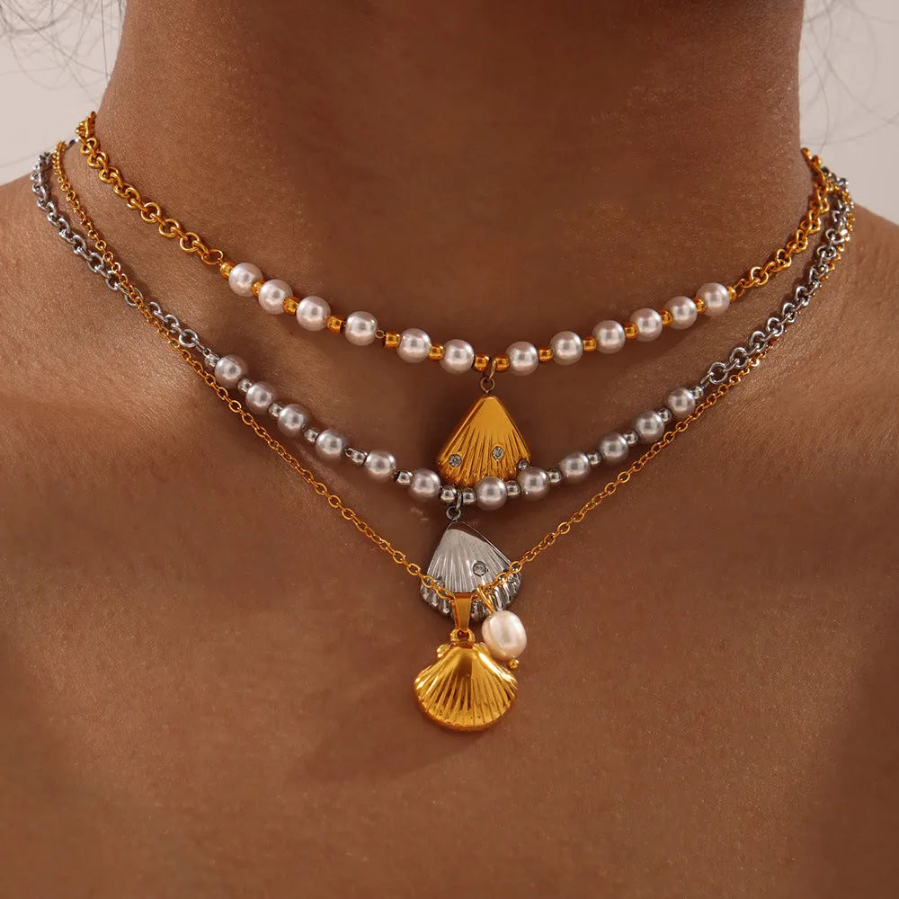 French vintage shell pendant necklace with titanium steel chain and freshwater pearl bead on gold background