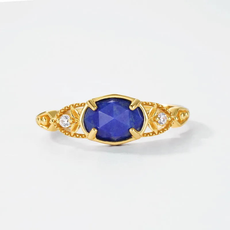 Elliptical lapis lazuli ring with sterling silver setting showing geometric design and natural stone colour variations
