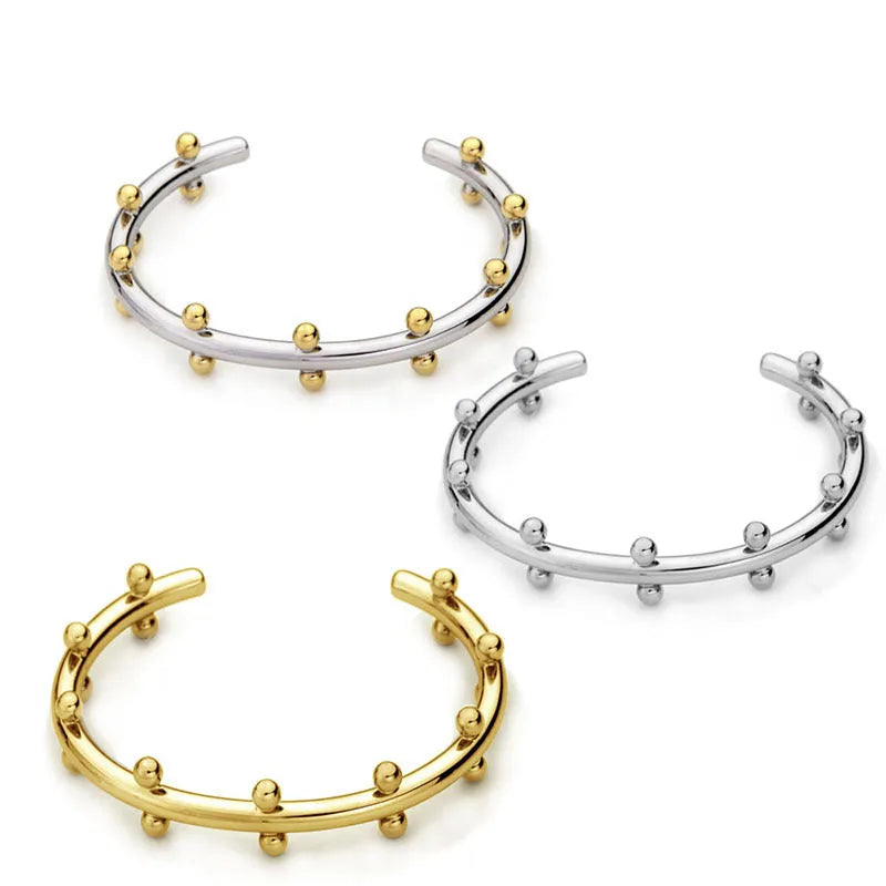 Stainless steel bracelet with C-shaped bean beads featuring texture rivet design in gold colour option