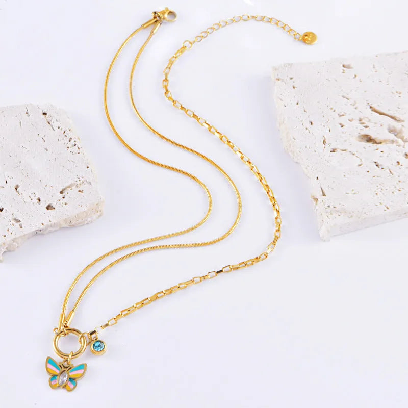 Gold titanium steel necklace and bracelet set with colourful epoxy butterfly and animal zodiac pendants.