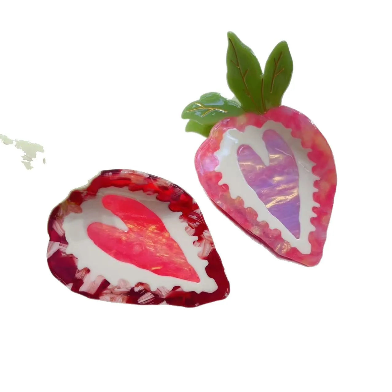 Handmade red strawberry hairpin with pastoral style design on a pink background