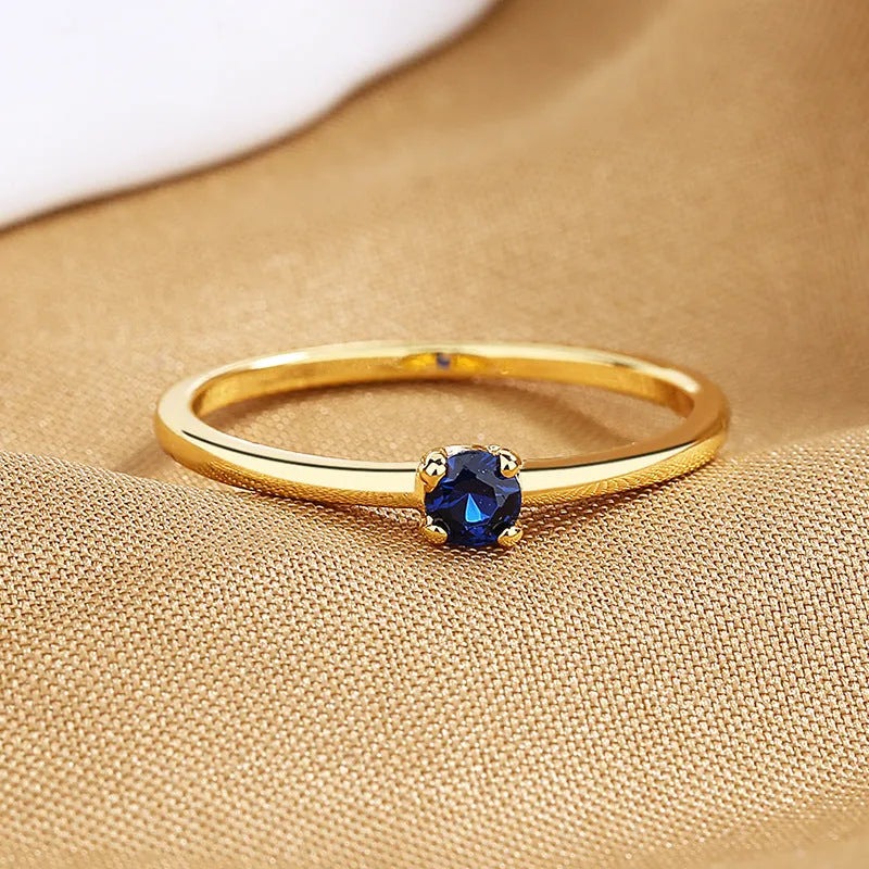 Copper geometric ring with single diamond accent in circle design, available in white, red, green, blue colours