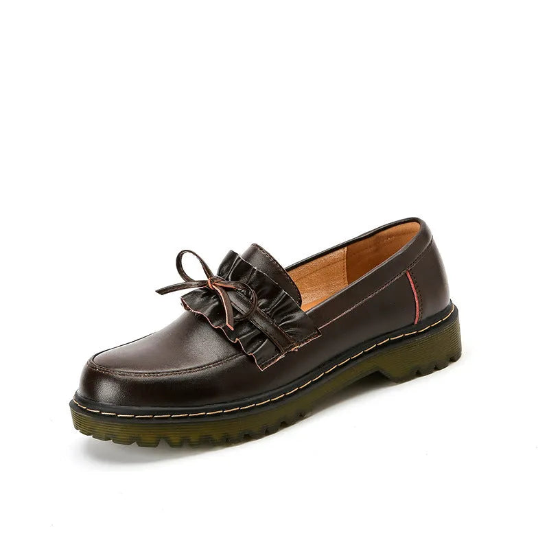 Women's black leather shoes with round toe and chunky flat heel in British style.