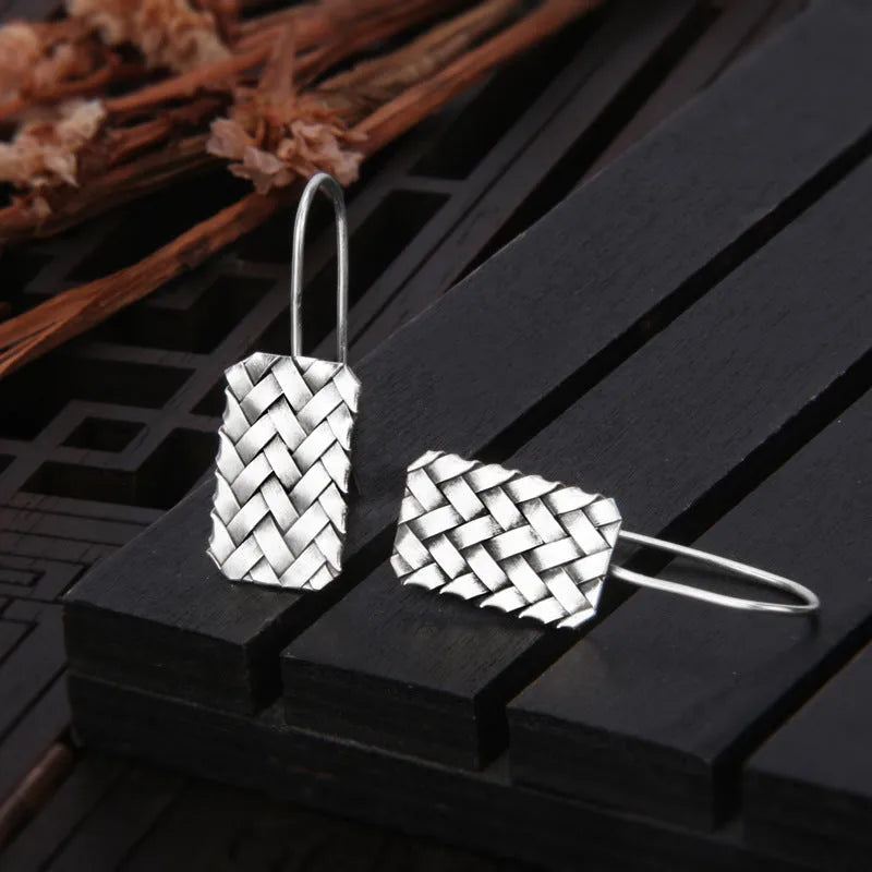 Silver geometric earrings with woven diamond plaid pattern, measuring 17.5mm by 11mm