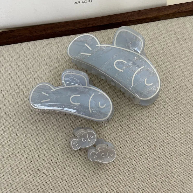 Dolphin grabber clip hair accessory for women in blue fish and pink dolphin colours, barrette style