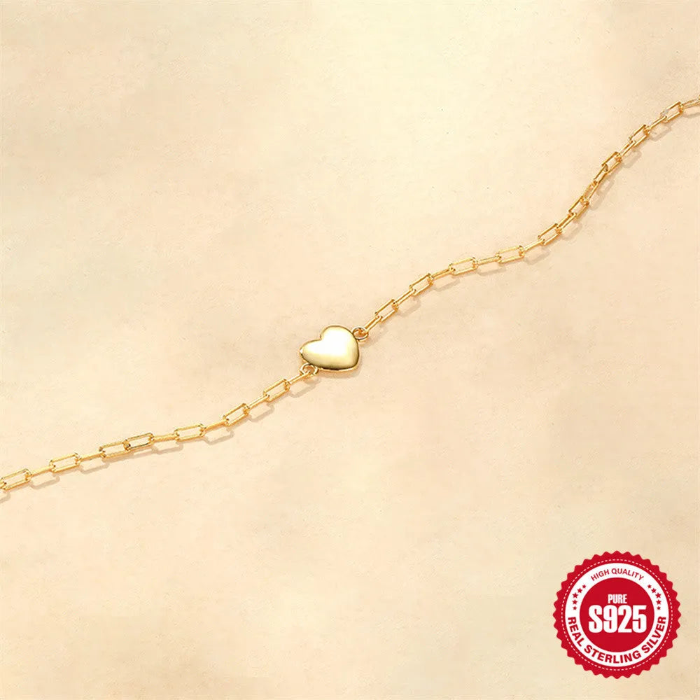 Gold S925 sterling silver women's bracelet with glossy geometric heart and clip chain.