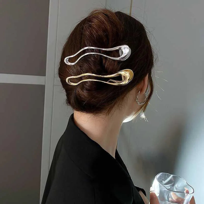 Women's zinc alloy barrettes in gold and silver colours showing arc, square, and triangle shapes