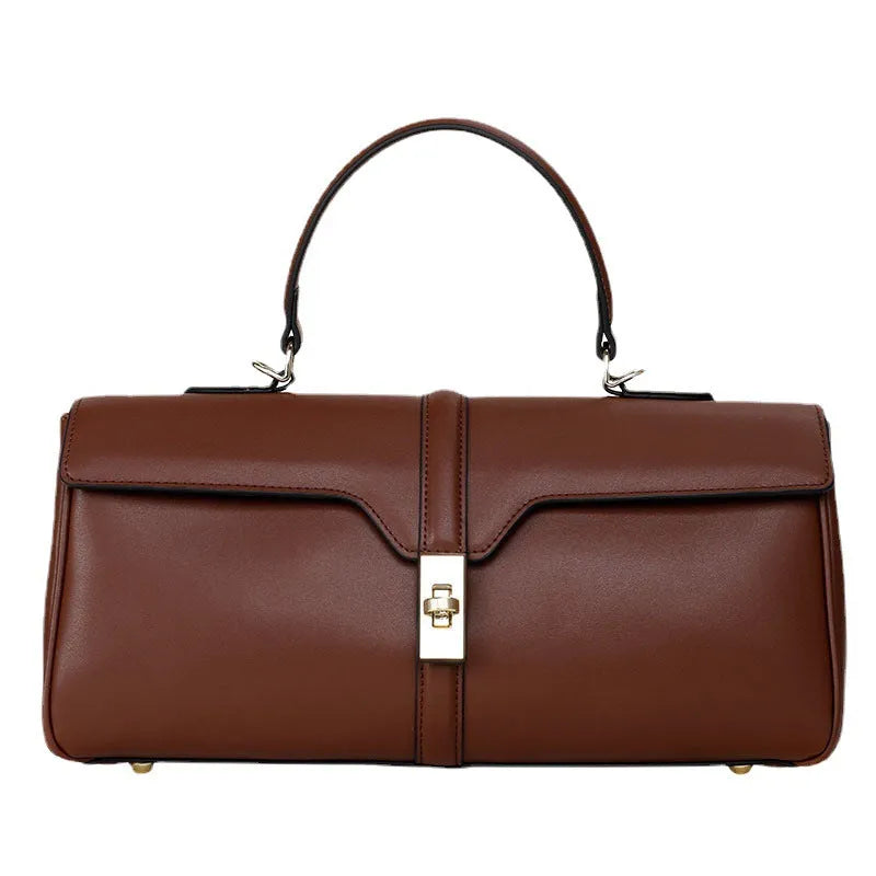 Women's cylindrical cowhide leather messenger bag in black or caramel colour with retro styling