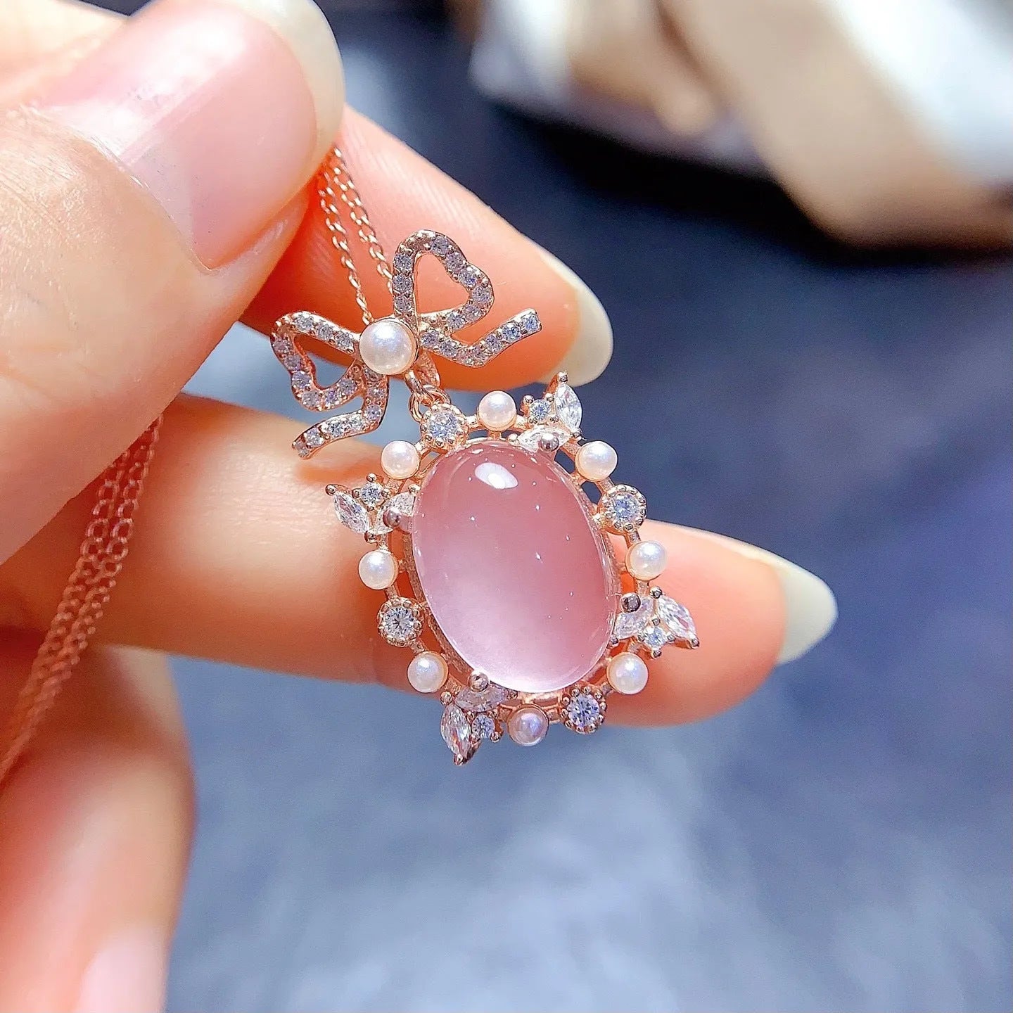 Geometric silver pendant with pink rose quartz crystal and rose gold plating on necklace chain