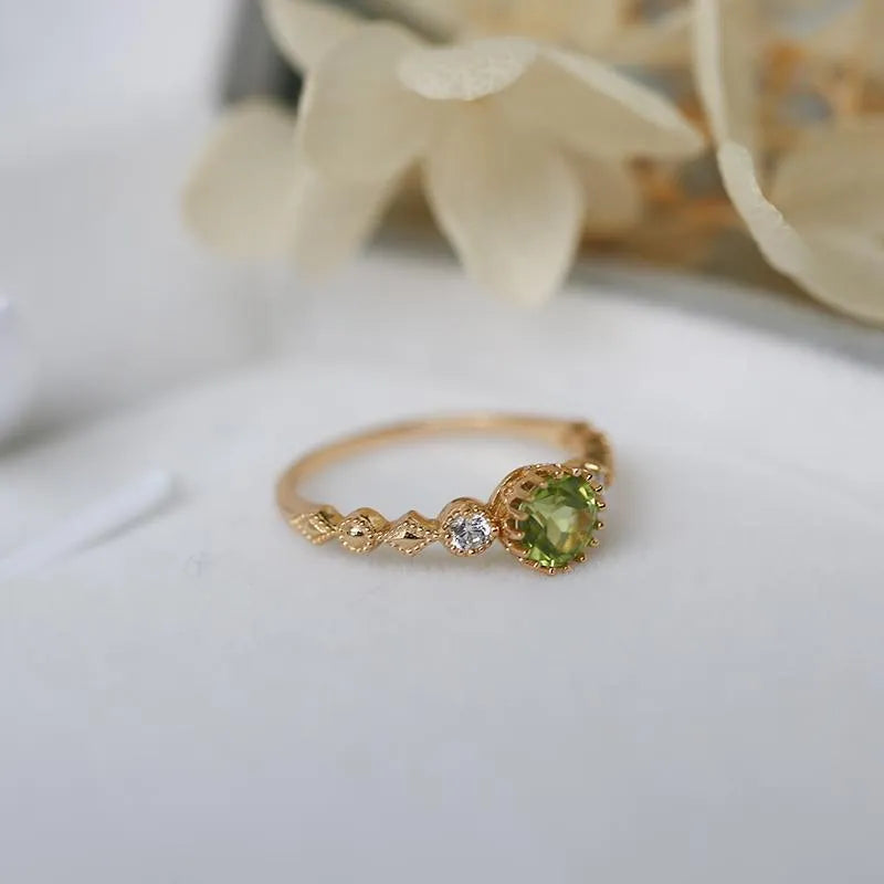 Quadrilateral geometric copper ring with imitation peridot stone, showing angular design and metallic finish