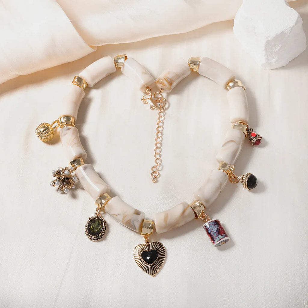 Heart-shaped plastic/resin pendant necklace with electroplated finish in picture colour
