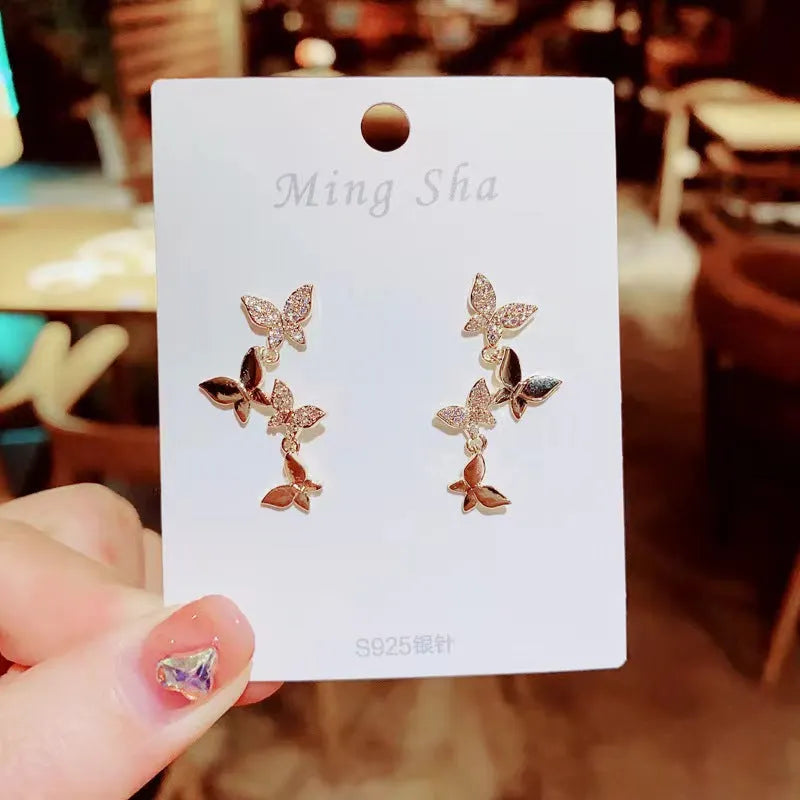 Women's gold-coloured copper butterfly earrings with four butterfly drop design