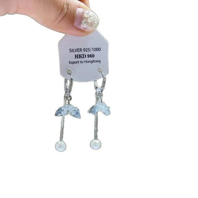 Geometric gold-tone clip-on earrings with a dangling tassel, rhinestone stars, and a heart charm.