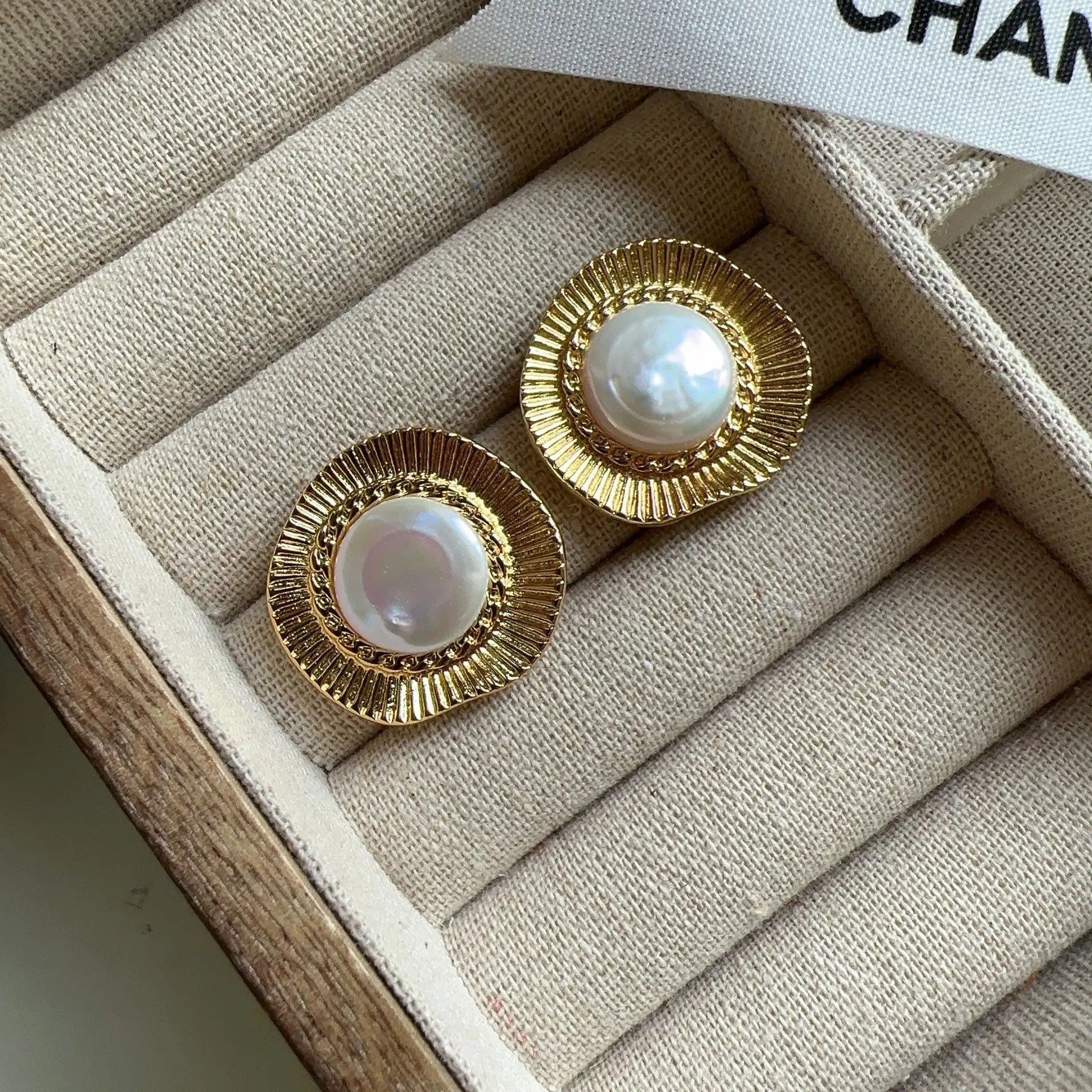 A pair of round gold-coloured retro style metal earrings for women.