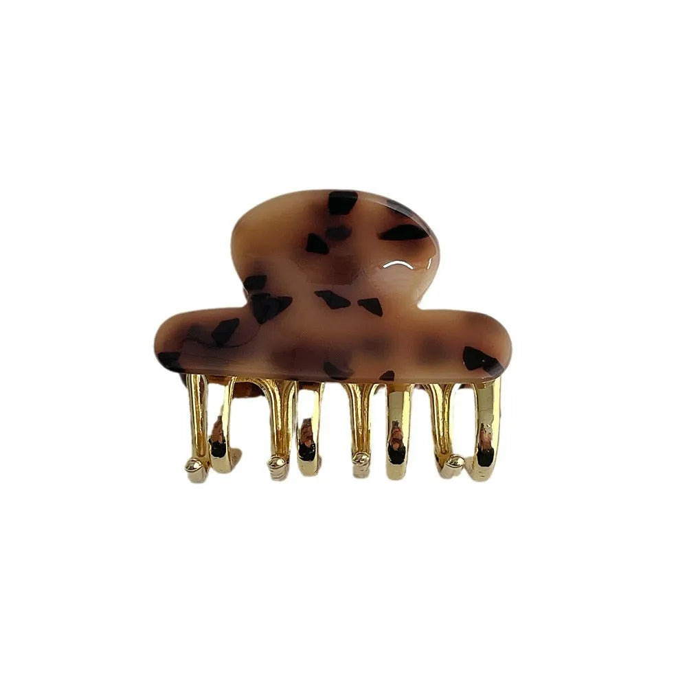 Set of retro-style alloy acrylic women's hair barrettes with metal grip in beige, white, ink and leopard print colours.