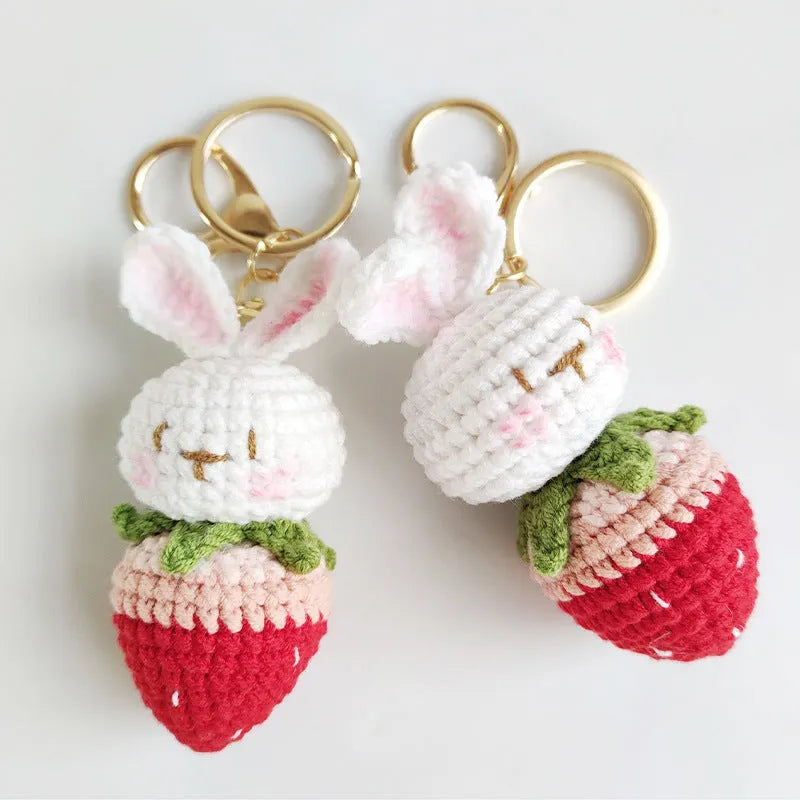 White hand-woven rabbit strawberry pendant with cartoon design and attached key on four-strand doll wire