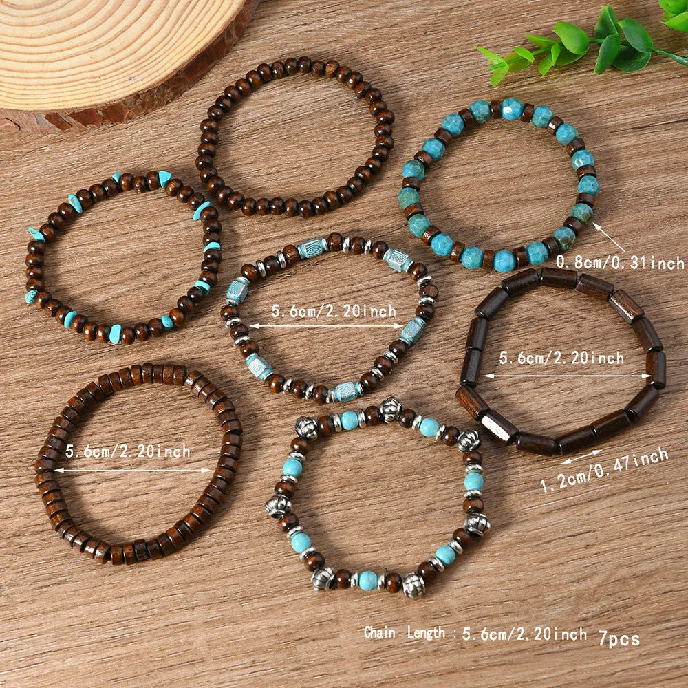 Seven multicolour retro bracelets with round wooden beads and alloy details laid out flat.