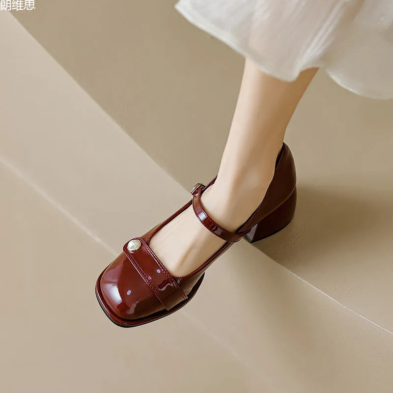 French-style women's chunky heel pumps with buckle fastening, square toe, in patent leather with rubber sole.