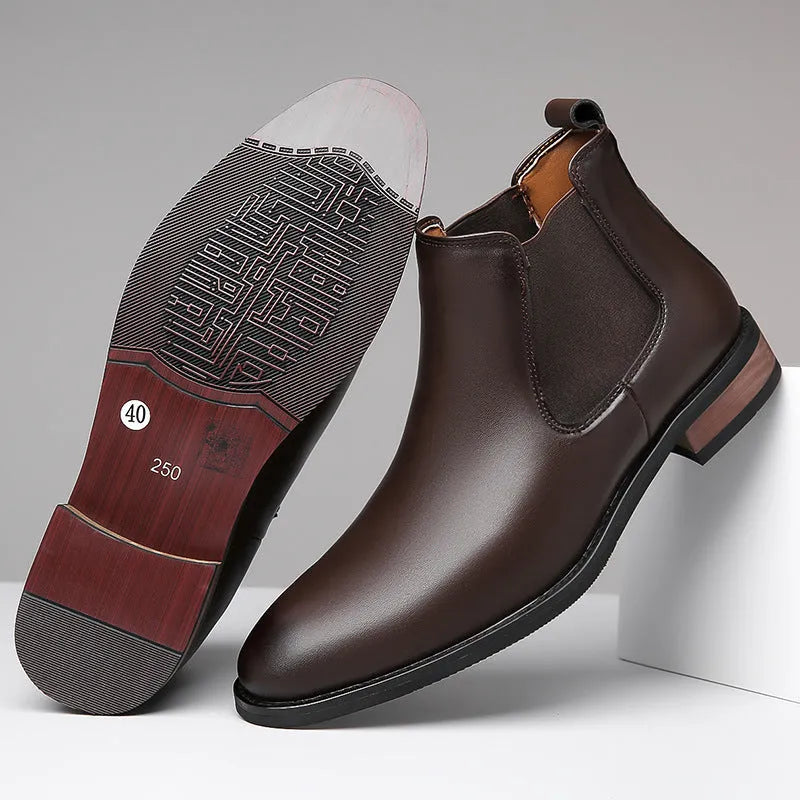 Men's black pointed toe Chelsea boots with a high-top design and decorative stitching on a rubber sole.