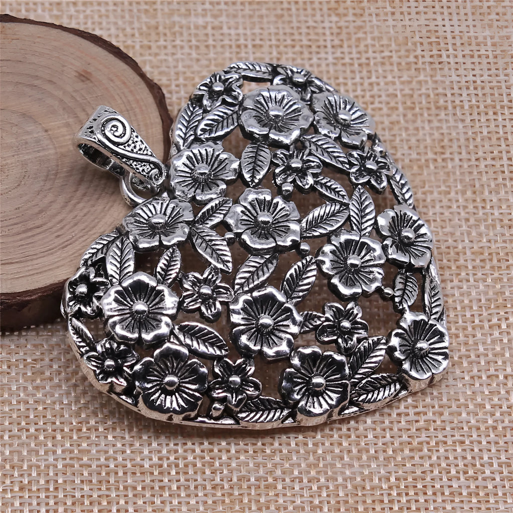 Ancient silver hollow flower alloy pendant measuring 67mm by 58mm