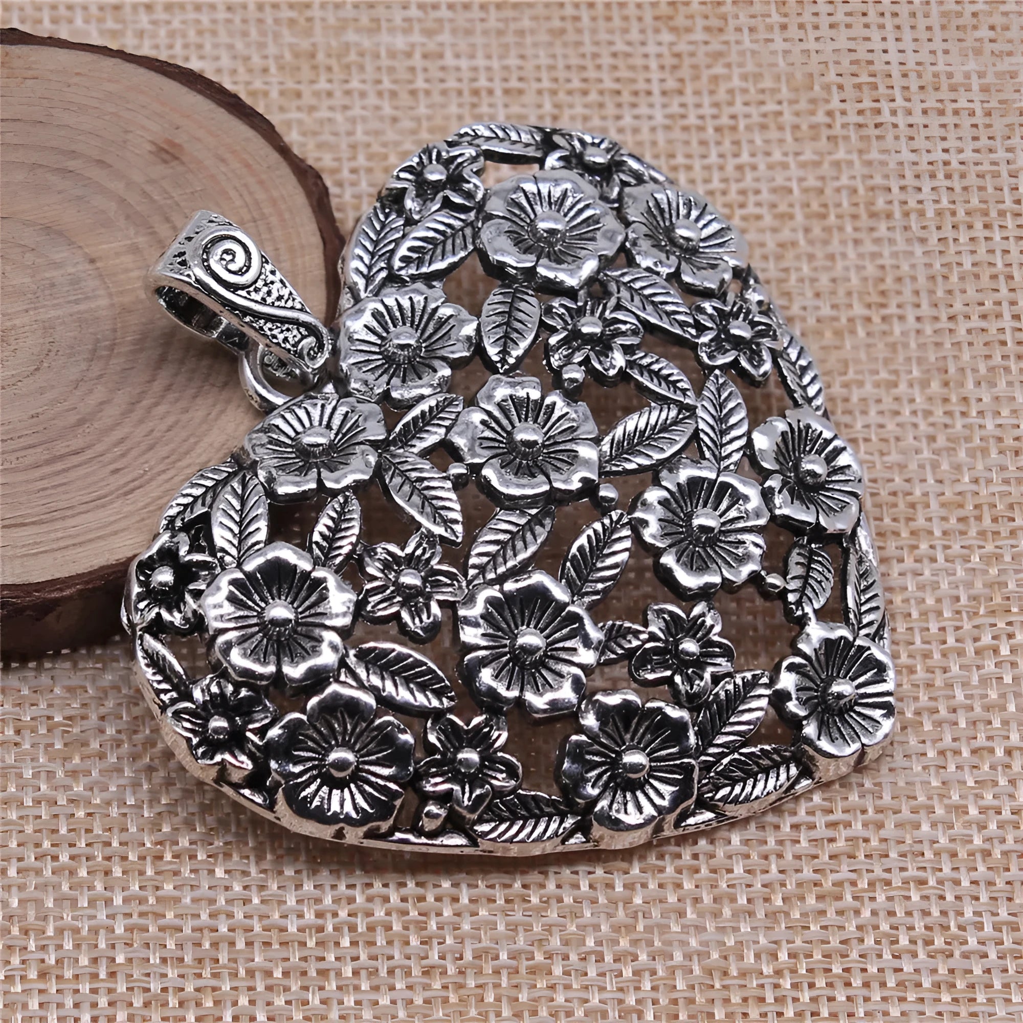Ancient silver hollow flower alloy pendant measuring 67mm by 58mm