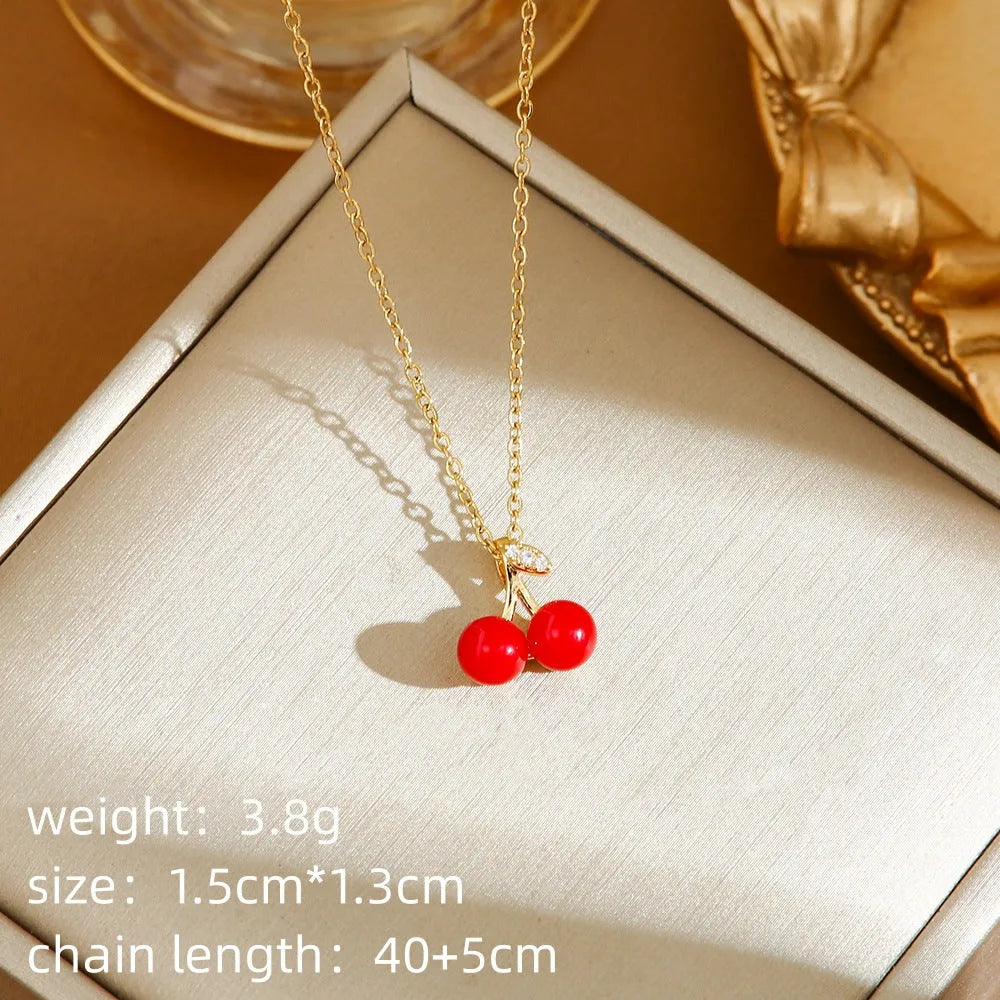 Titanium steel necklace with O-ring chain and delicate fruit pendant in golden cherry finish