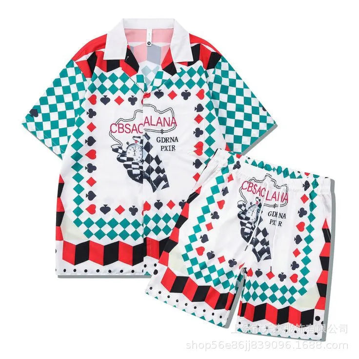 Plaid patterned short-sleeve shirt and matching trousers laid flat, a blue and white beachwear set.
