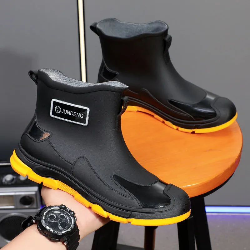 A pair of minimalist Korean-style PVC waterproof boots for adults with a non-slip sole.
