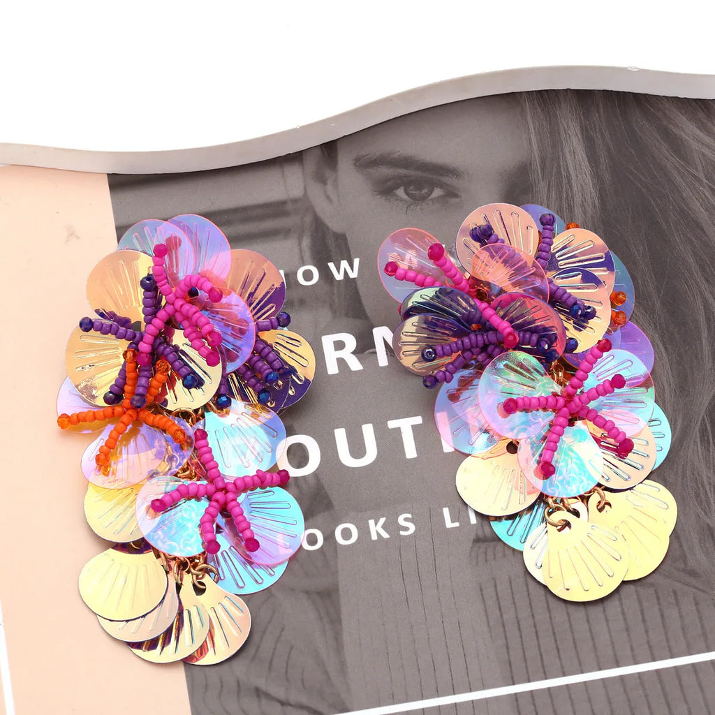 Handmade string bead flower earrings with exaggerated floral designs in rose and purple colours, measuring 5-7cm