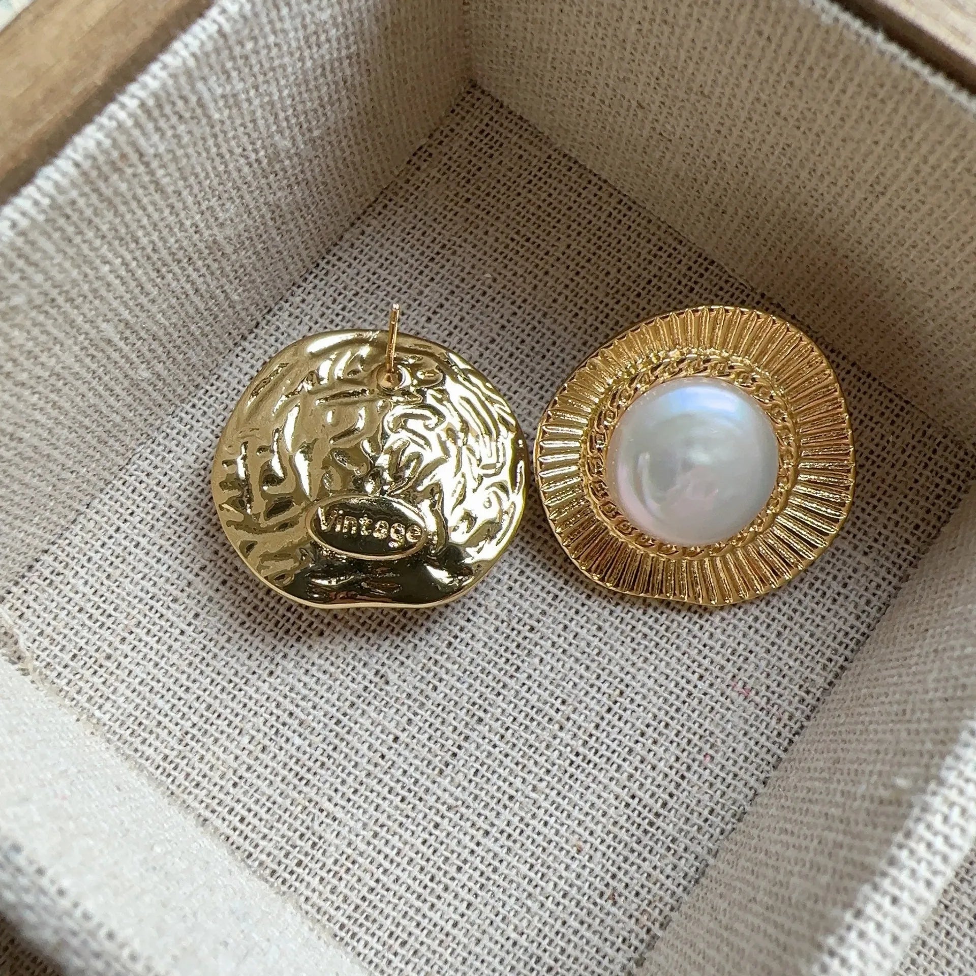 A pair of round gold-coloured retro style metal earrings for women.