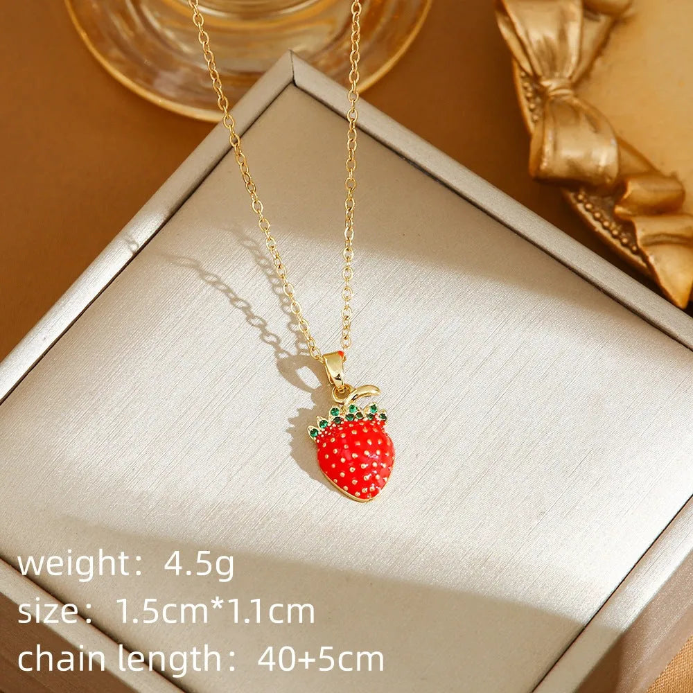 Titanium steel necklace with O-ring chain and delicate fruit pendant in golden cherry finish