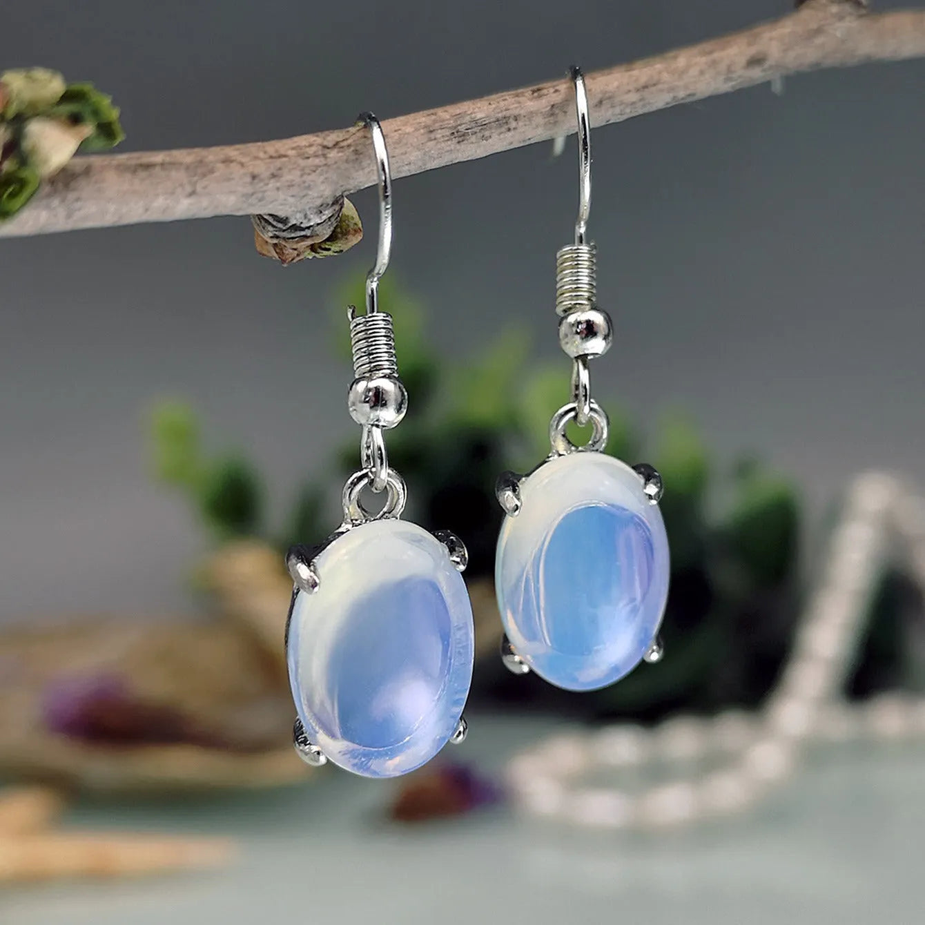 Electroplated alloy opal earrings with moonlight white finish and retro moonstone drop design featuring cross motif