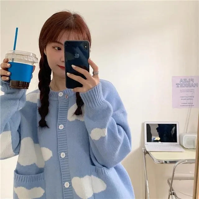 Blue loose-fit women's spandex cardigan sweater with a white cloud pattern.
