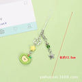 Red and green fruit-themed plastic mobile phone charm and keychain on a white background.