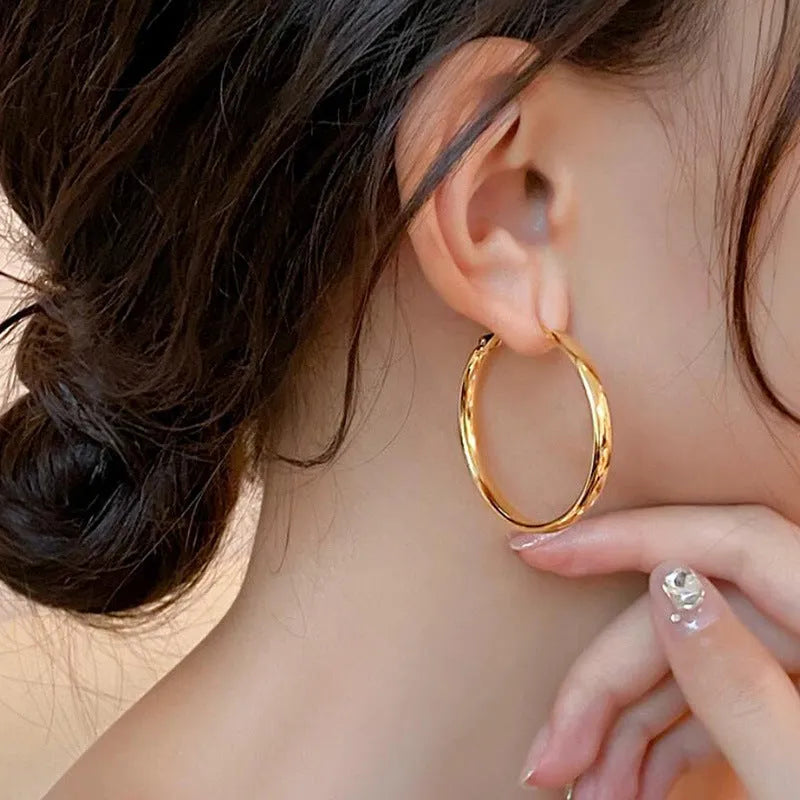 Pair of 40mm diameter circle earrings with electroplated gold or silver finish on copper