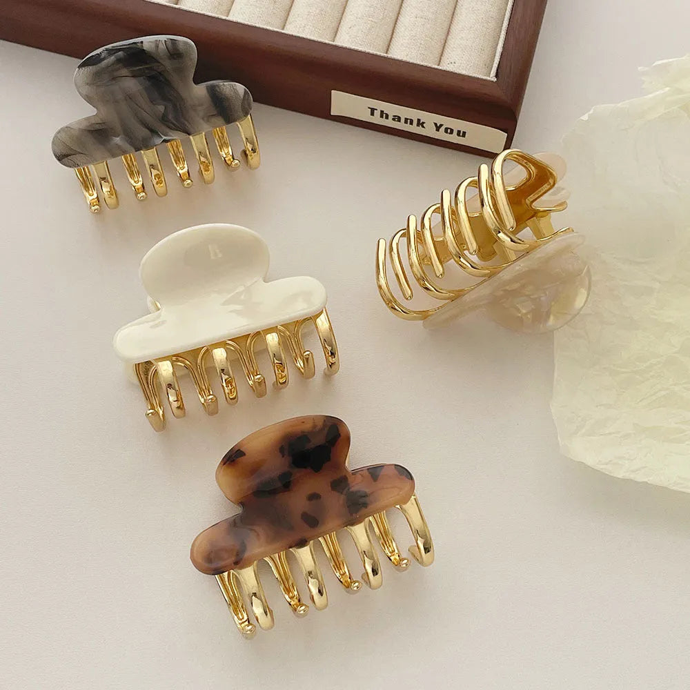 Set of retro-style alloy acrylic women's hair barrettes with metal grip in beige, white, ink and leopard print colours.