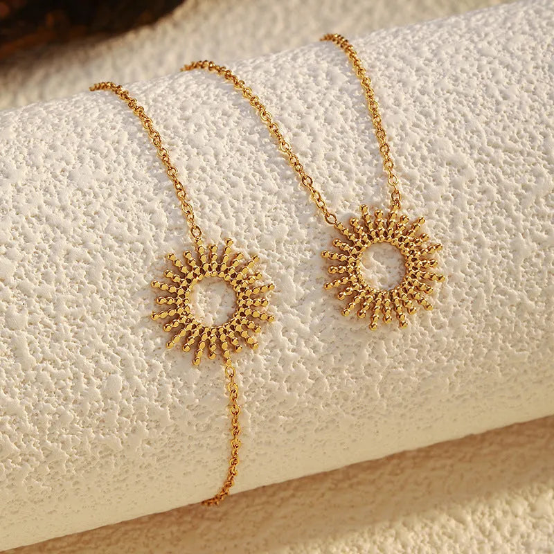 SUNFLOWER Series gold bracelet and necklace set with geometric chain design on a white background
