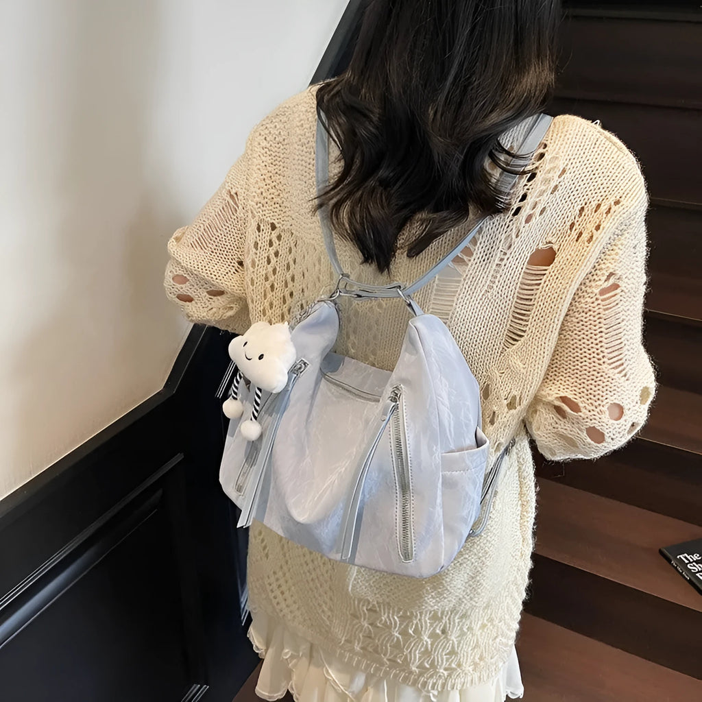 Women's soft PU fashion backpack in four colours with wear-resistant construction and included pendant accessory