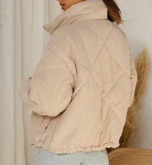 Women's apricot corduroy jacket with stand collar, long sleeves, and zipper closure, showing textured fabric and wadded design.