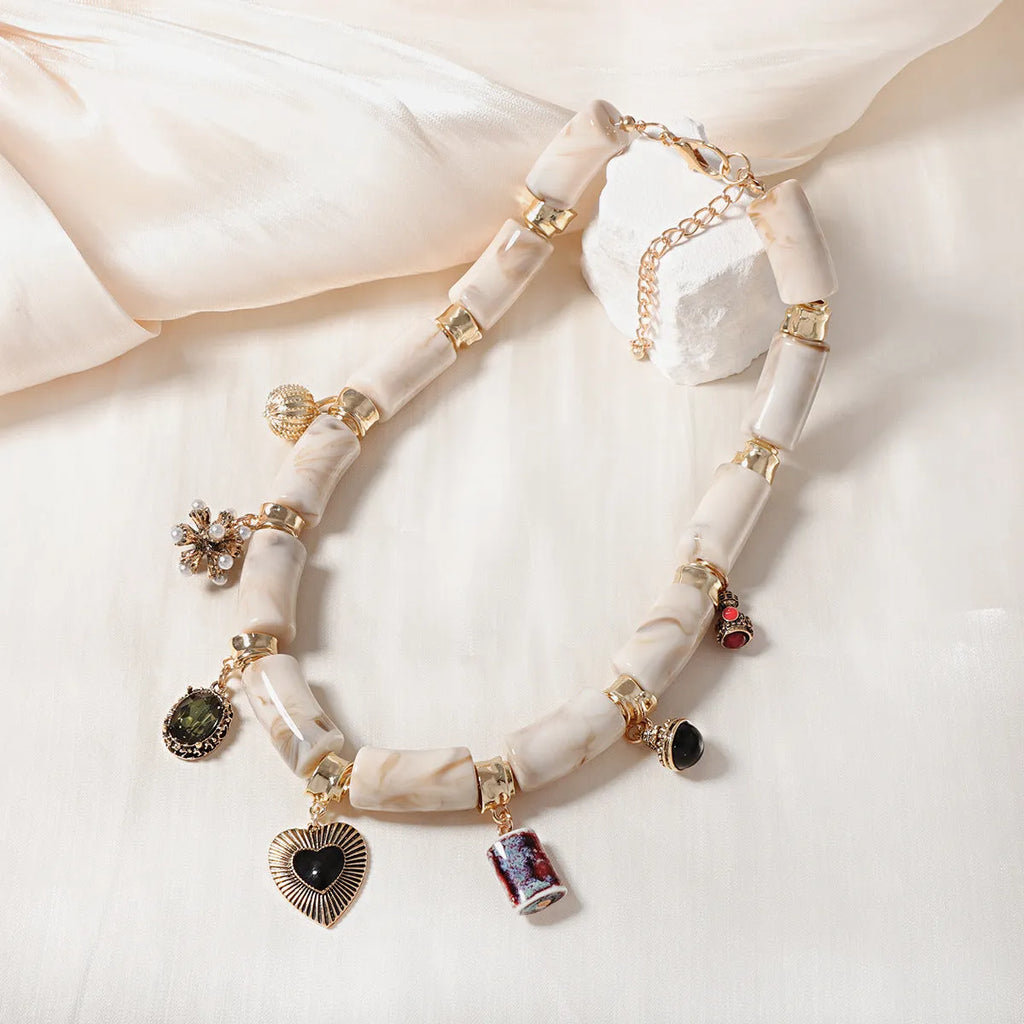 Heart-shaped plastic/resin pendant necklace with electroplated finish in picture colour