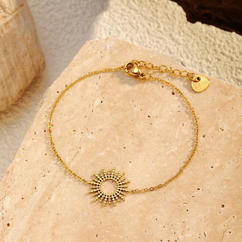 SUNFLOWER Series gold bracelet and necklace set with geometric chain design on a white background