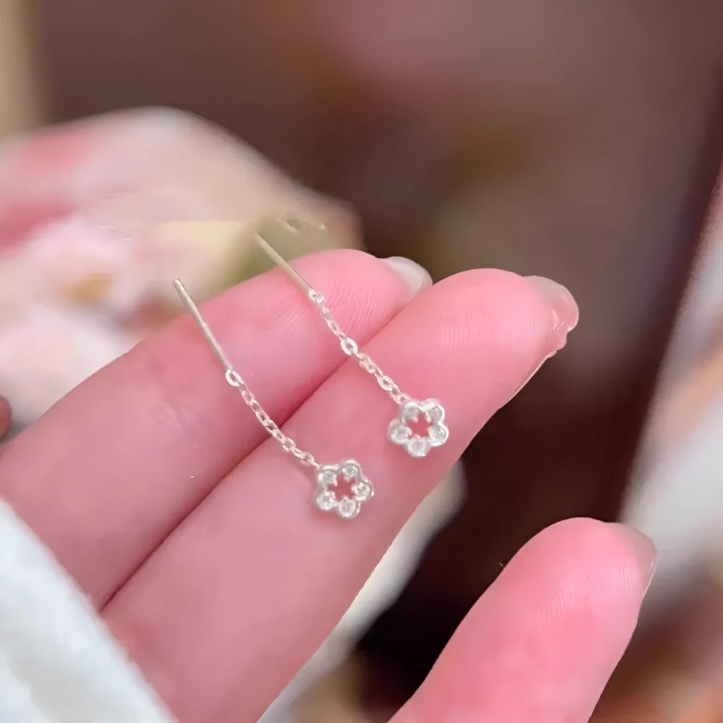 Silver hollow flower stud earrings with natural petal design on alloy backing