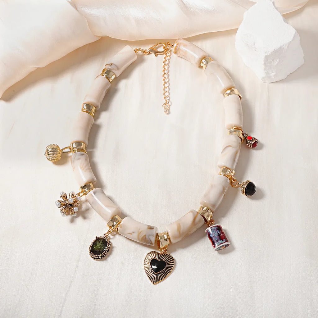 Heart-shaped plastic/resin pendant necklace with electroplated finish in picture colour