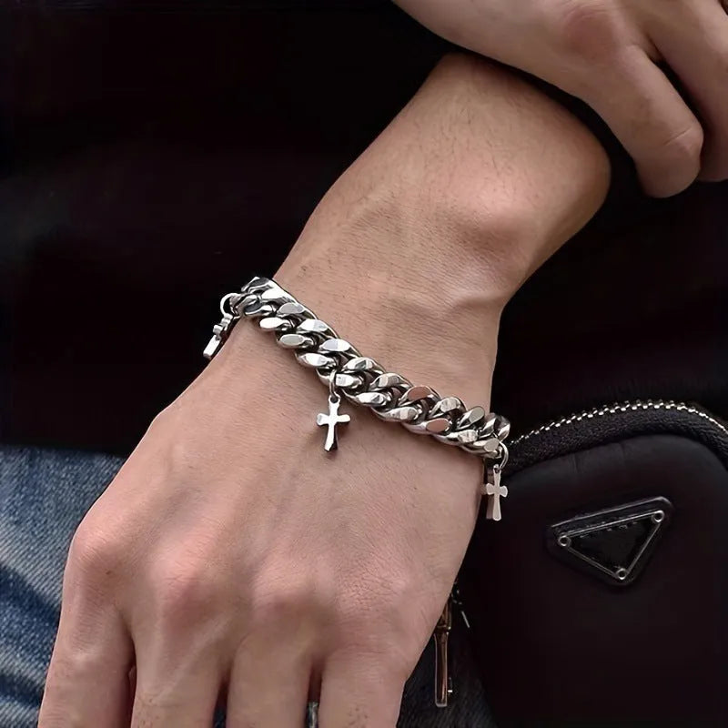 Men's titanium steel bracelet with geometric cross design on wrist, showing adjustable clasp and matte finish