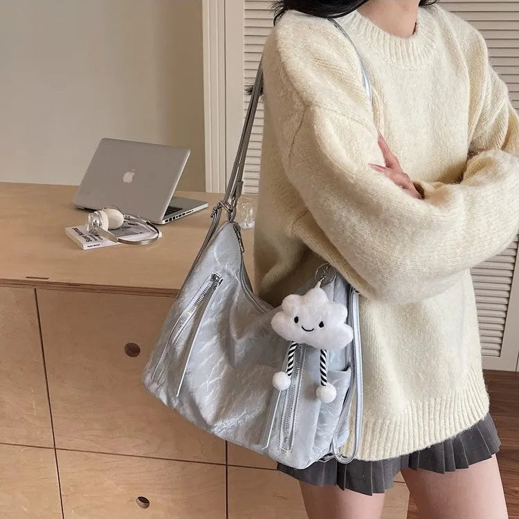 Women's soft PU fashion backpack in four colours with wear-resistant construction and included pendant accessory