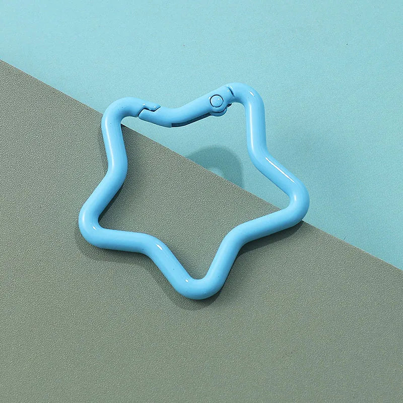 Zinc alloy five-pointed star keychain in assorted colours measuring 2.5 cm across with hanging loop