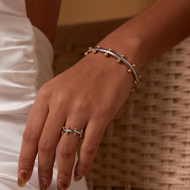 Stainless steel C-shaped bracelet with rivet texture bean beads and alloy clasp in gold colour option