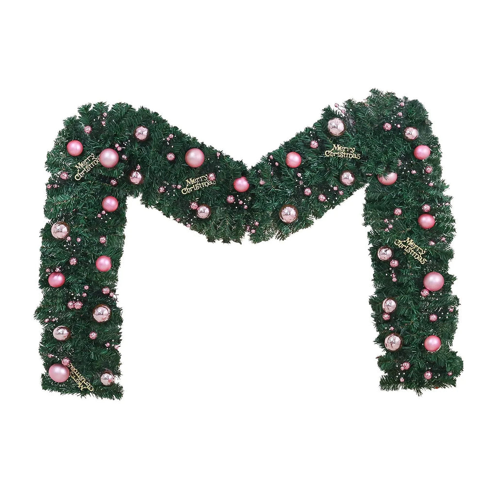 Pink rattan Christmas vine decoration with small fruit ornaments, 2.7 metres long, on a wall display