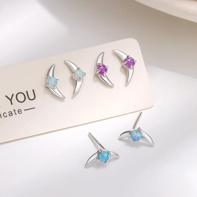 Women's geometric earrings in 925 silver with electroplated finish, showing colour options with blue, purple, and white stones.